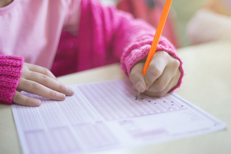 child marking optical test answer form