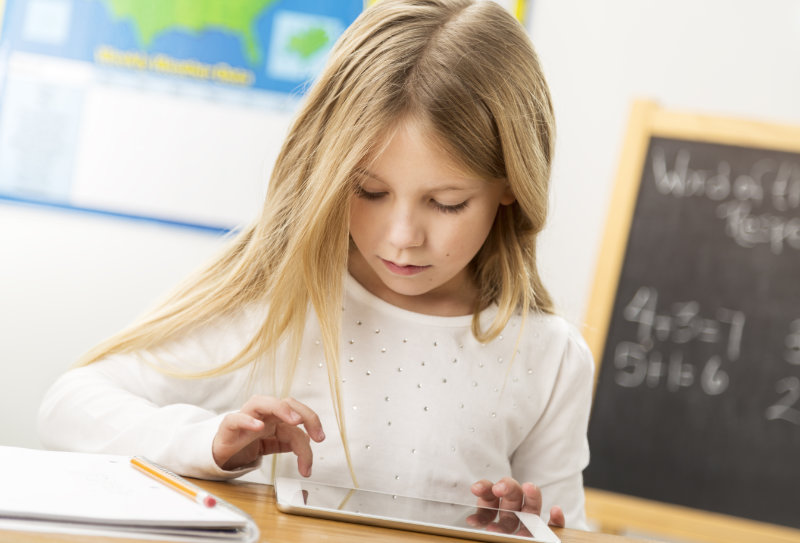 young girl taking test on an i-pad