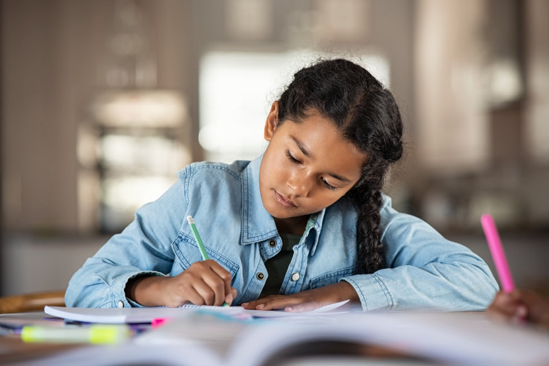 Indian little girl studying at home